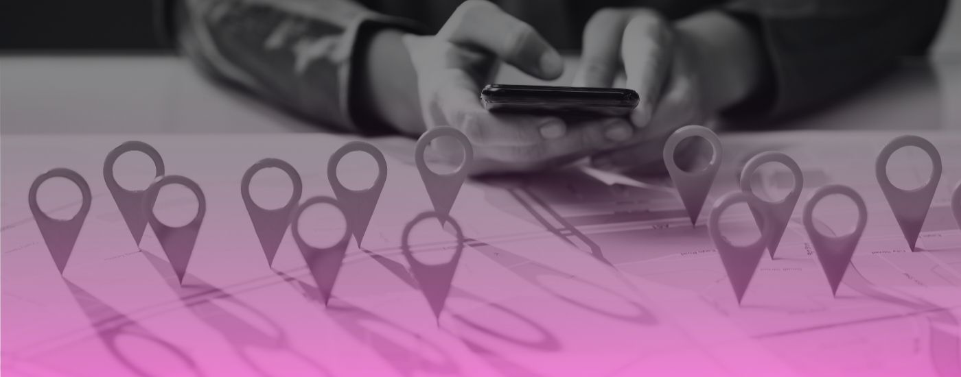 person in front of map with several pins hovering over map