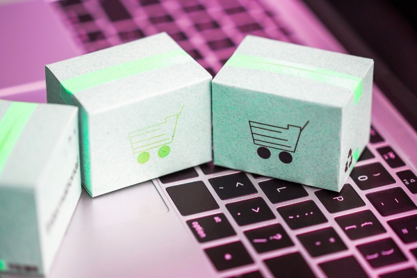 packages with shopping cart icons on top of a keyboard