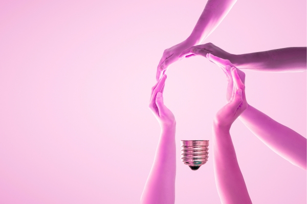 hands around a lightbulb