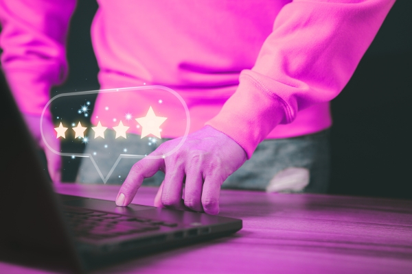 hands typing on a keyboard with a comment bubble that shows 5 stars