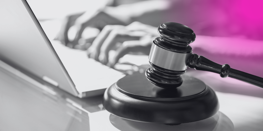 person on laptop with judge's gavel in the foreground